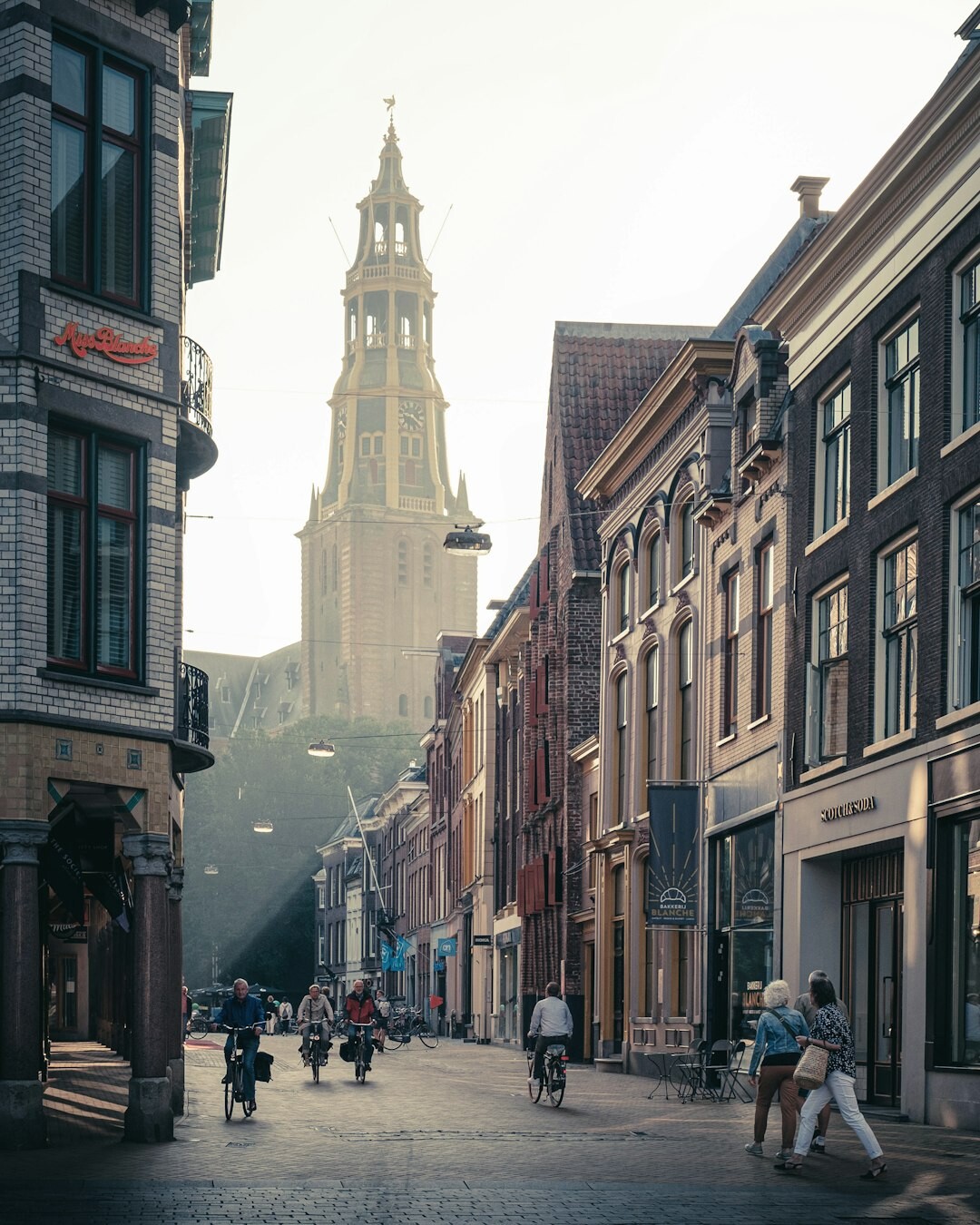 Documentary photo of a small Scandinavian town street with pedestrians and old brick buildings