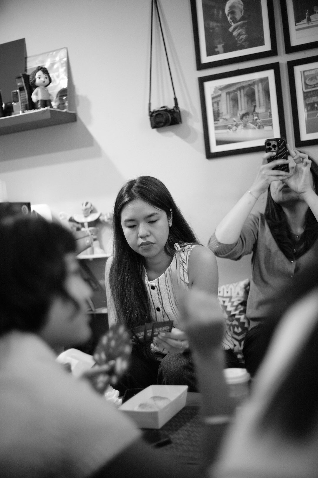 Small editorial team discussing photographs around a table