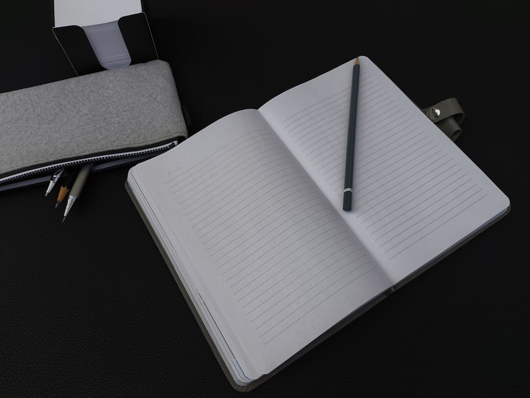 Journalist writing notes in a notebook at a desk
